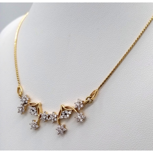 6 - An elegant 18 K yellow gold necklace with with a flower design loaded with diamonds (0.70 carats), l... 