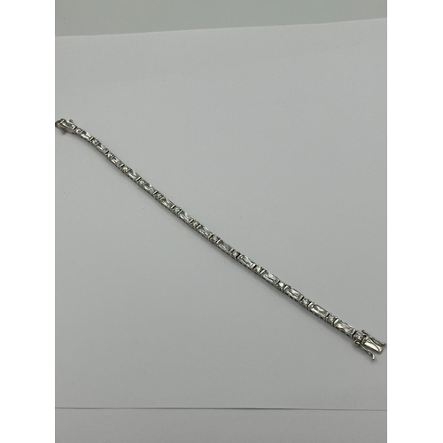 259 - Hallmarked SILVER TENNIS BRACELET set with sparkling Princess cut and Round cut Zirconias. 19 cm.