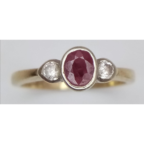 410 - A 9 K yellow gold ring with an oval cut ruby and two round cut diamonds (0.10 carats), ring size: J1... 