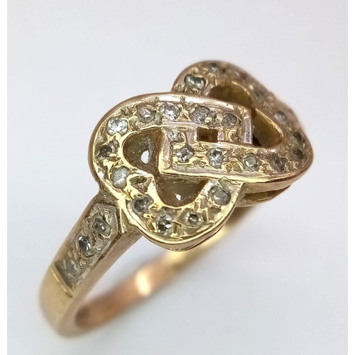 211 - A vintage 9 K yellow gold ring with two inter-twined diamond hearts. Ring size: L, weight: 2.6 g.