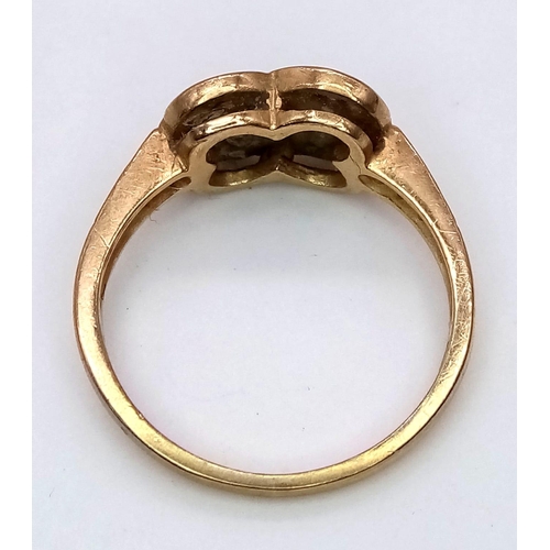 211 - A vintage 9 K yellow gold ring with two inter-twined diamond hearts. Ring size: L, weight: 2.6 g.