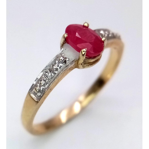 232 - A 9 K yellow gold ring with an oval cut natural ruby and a band of diamonds on each shoulder of the ... 