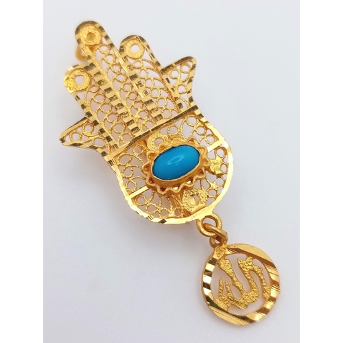 1103 - An 18K Yellow Gold 'Hand of God' Brooch. Turquoise cabochon decoration. 4.5cm. 3.5g total weight.