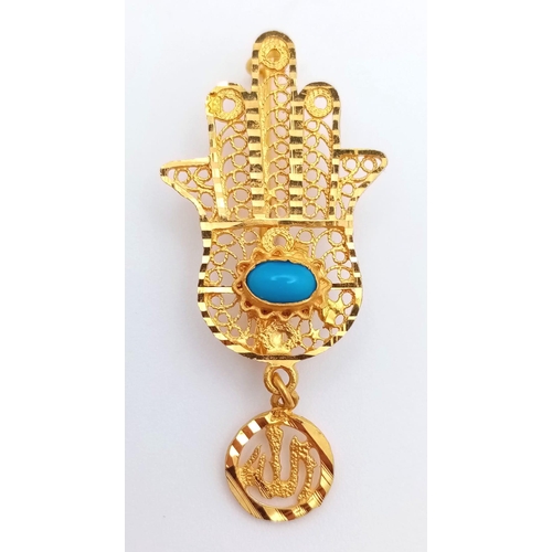 1103 - An 18K Yellow Gold 'Hand of God' Brooch. Turquoise cabochon decoration. 4.5cm. 3.5g total weight.