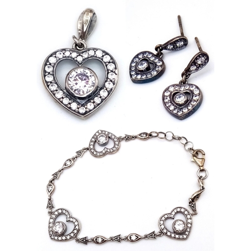 1106 - A matching set of 925 silver Zirconia jewellery include a pair of earrings, a pendant and a link bra... 