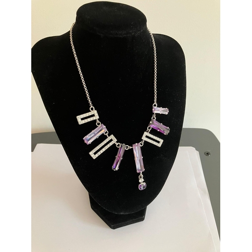 1101 - SILVER BELCHER NECKLACE Set with lilac and purple gemstones together with zirconia detail. ‘T’ bar f... 