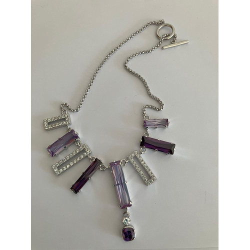 1101 - SILVER BELCHER NECKLACE Set with lilac and purple gemstones together with zirconia detail. ‘T’ bar f... 