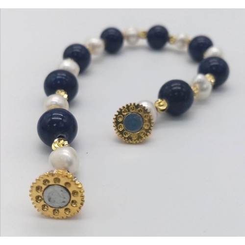 1573 - A Lapis Lazuli and Cultured Pearl Bracelet. Gilded clasp and spacers. 18cm