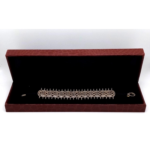 22 - A Diamond Tennis Bracelet with 10ctw (approx) of round cut diamonds set in 925 Silver on a black tex... 