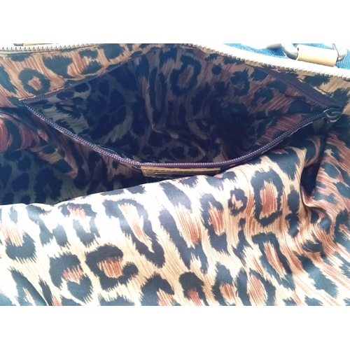 1100 - A Dolce and Gabbana Denim and Leather Handbag. Tasselled exterior zip. Leopard print textile interio... 