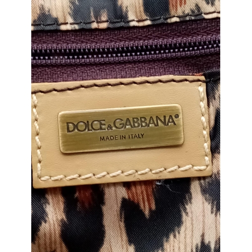 1100 - A Dolce and Gabbana Denim and Leather Handbag. Tasselled exterior zip. Leopard print textile interio... 