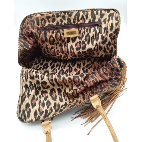 1100 - A Dolce and Gabbana Denim and Leather Handbag. Tasselled exterior zip. Leopard print textile interio... 