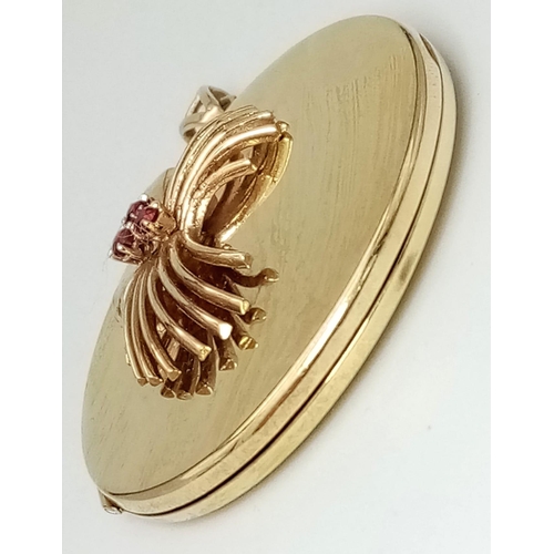 37 - A SOLID 9K GOLD LOCKET STYLE PENDANT WITH GARNET DECORATION . 20.4gms    4.5cms DIAMETER  14954