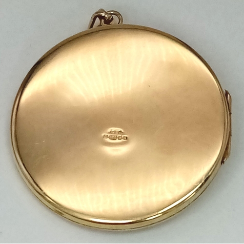 37 - A SOLID 9K GOLD LOCKET STYLE PENDANT WITH GARNET DECORATION . 20.4gms    4.5cms DIAMETER  14954