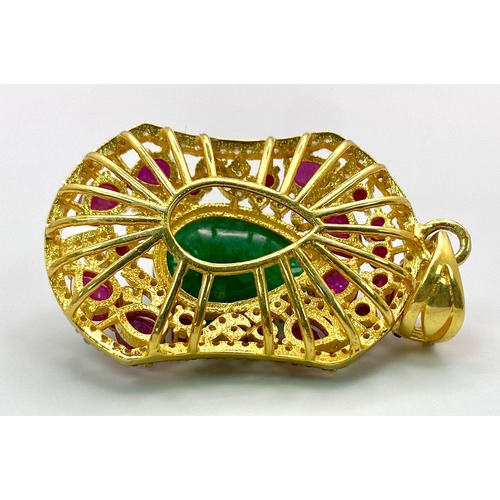 234 - An Emerald, Ruby and Diamond Shield Pendant set in Gold Plated 925 Silver. A central 8ct teardrop em... 