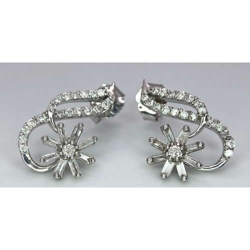 352 - A PAIR OF 9K WHITE GOLD FANCY DIAMOND SET SWIRL EARRINGS. 0.40ctw, 2.4g total weight.    Ref: SC1136