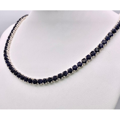 57 - A Blue Sapphire Gemstone Tennis Necklace set in 925 Silver. 
45cm length. 40.15g total weight.