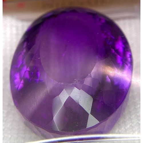 981 - A 128.70ct Brazilian Deep Purple Amethyst, in the Oval Faceted cut. Comes with the AIG certificate. ... 