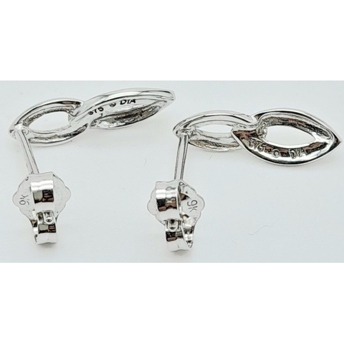 306 - A Pair of 9K White Gold Diamond Set Drop Earrings. 1.5cm length, 1.2g total weight.   Ref: SC1135