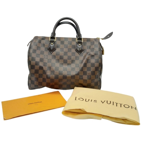 36 - A Louis Vuitton Speedy Bag. Checked LV canvas exterior. Red textile interior. Comes with dust cover,... 