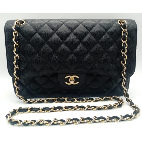 3 - A Chanel Black Caviar Classic Double Flap Bag. Quilted pebbled leather exterior with gold-toned hard... 