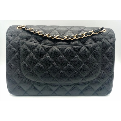 3 - A Chanel Black Caviar Classic Double Flap Bag. Quilted pebbled leather exterior with gold-toned hard... 