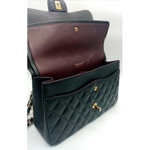 3 - A Chanel Black Caviar Classic Double Flap Bag. Quilted pebbled leather exterior with gold-toned hard... 