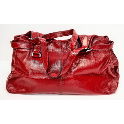 156 - A Mulberry Patent Red Leather Handbag. Textured exterior with a central zipped pocket. Silver-tone h... 