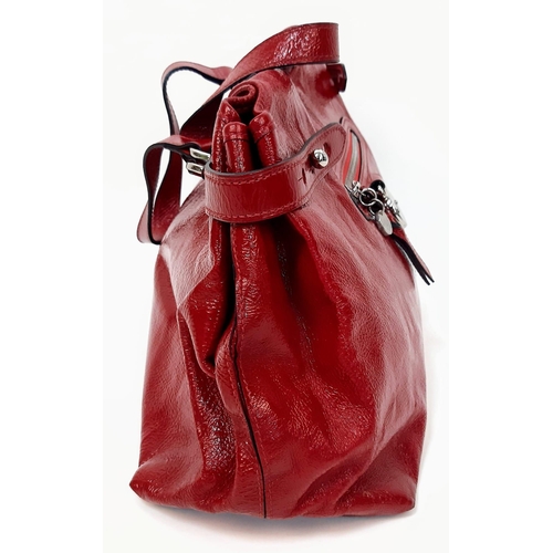 156 - A Mulberry Patent Red Leather Handbag. Textured exterior with a central zipped pocket. Silver-tone h... 