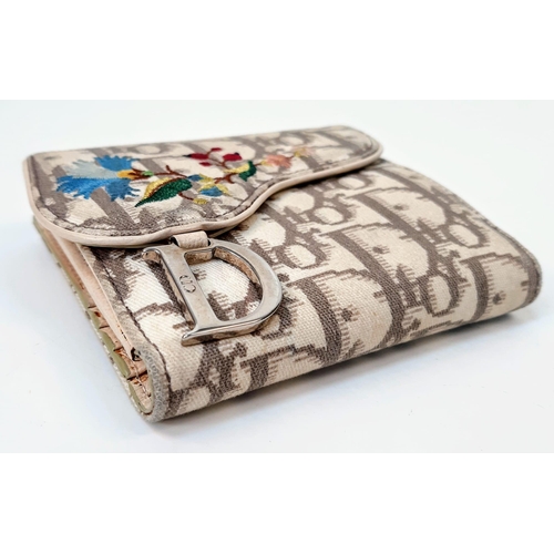 172 - A Christian Dior Wallet. Exterior Dior branding with colourful floral decoration. Two interior open ... 