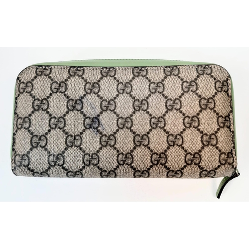 180 - A Gucci Monogram Wallet. Canvas and green leather exterior. Spacious green leather interior with mul... 