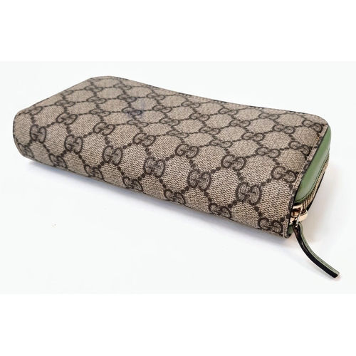 180 - A Gucci Monogram Wallet. Canvas and green leather exterior. Spacious green leather interior with mul... 