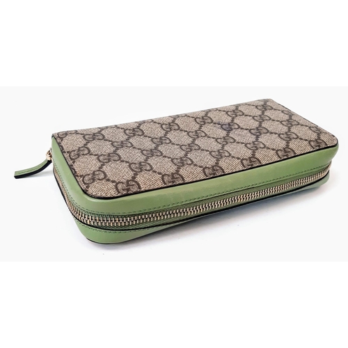 180 - A Gucci Monogram Wallet. Canvas and green leather exterior. Spacious green leather interior with mul... 