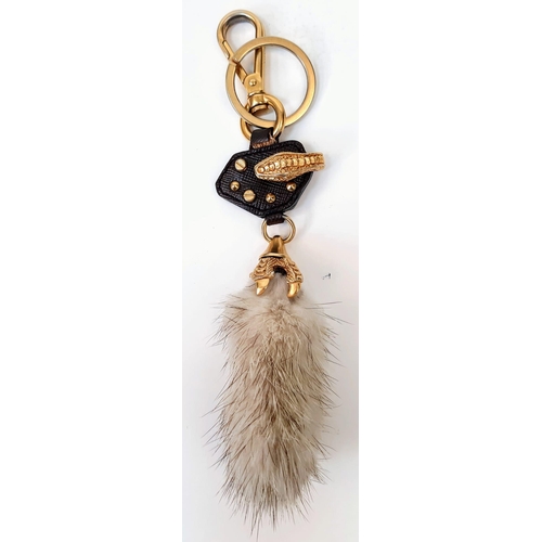 188 - A Prada Furry Key Ring! Gilded hardware with a tough leather body and furry finish. Comes with a dus... 