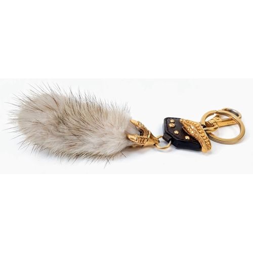 188 - A Prada Furry Key Ring! Gilded hardware with a tough leather body and furry finish. Comes with a dus... 