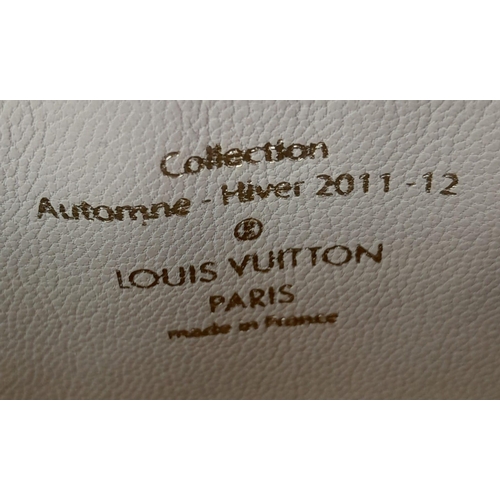 782 - A Louis Vuitton Lockit Fetish Clutch Bag. Monogram canvas with gold tone hardware. Lock and keys. Be... 