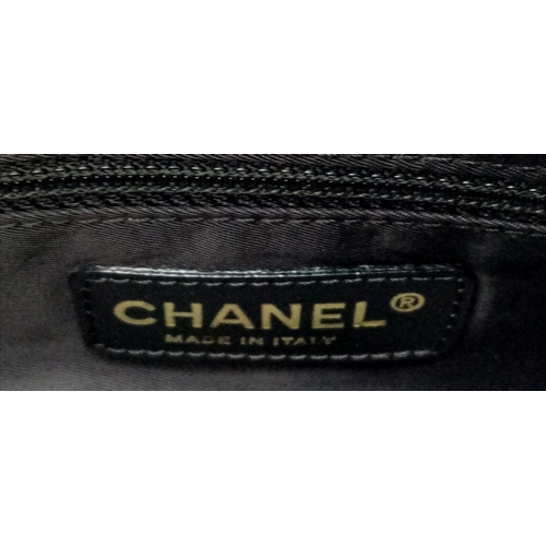 348 - A Chanel Black Travel Line Bag. Canvas exterior with leather straps, four protective base studs and ... 