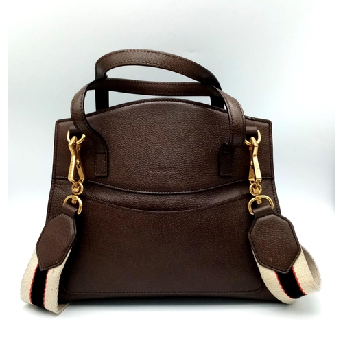 390 - A Gucci Linea Butterfly Clasp Satchel. Brown calfskin leather exterior with decorative white stone b... 