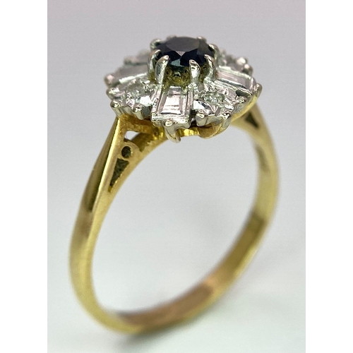 583 - An 18K Yellow Gold Fancy Floral Diamond and Sapphire Ring. A central sapphire with round diamonds an... 