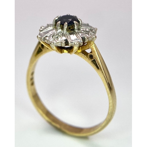 583 - An 18K Yellow Gold Fancy Floral Diamond and Sapphire Ring. A central sapphire with round diamonds an... 