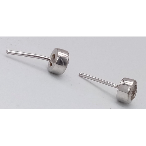 1049 - A Pair of 14K White Gold Tinted Diamond Stud Earrings. No backs. 1.85g total weight. Ref: 15817