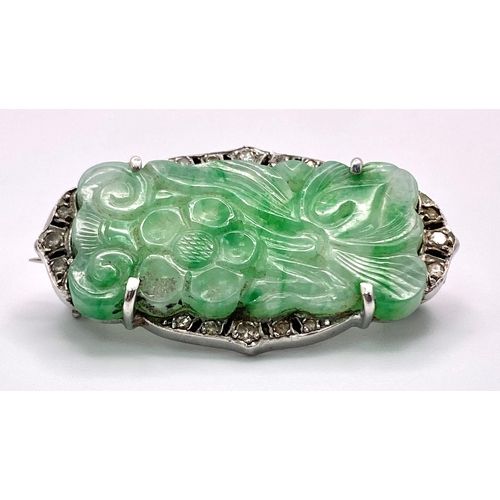 628 - A Wonderful Art Deco Platinum, Diamond and Jade Brooch. A Chinese green and white pierced decorative... 