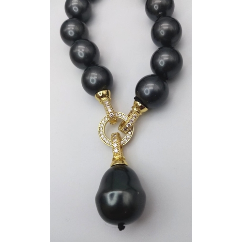 687 - A Metallic Dark Grey South Sea Pearl Shell Bead Necklace with Hanging Teardrop Pendant. 12mm beads. ... 