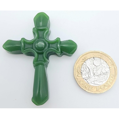 852 - A Green Jade Decorative Cross Pendant. 5cm x 4cm