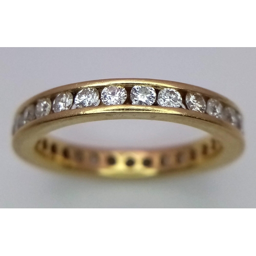 94 - AN 18K YELLOW GOLD DIAMOND SET FULL ETERNITY BAND RING.  APPROX 1CT. 4G. SIZE M 1/2