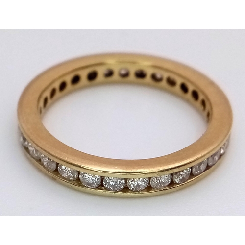 94 - AN 18K YELLOW GOLD DIAMOND SET FULL ETERNITY BAND RING.  APPROX 1CT. 4G. SIZE M 1/2