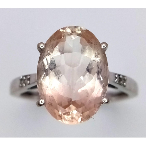 541 - A 9K WHITE GOLD DIAMOND & PEACH STONE SET COCKTAIL RING. 3.5G. SIZE R.