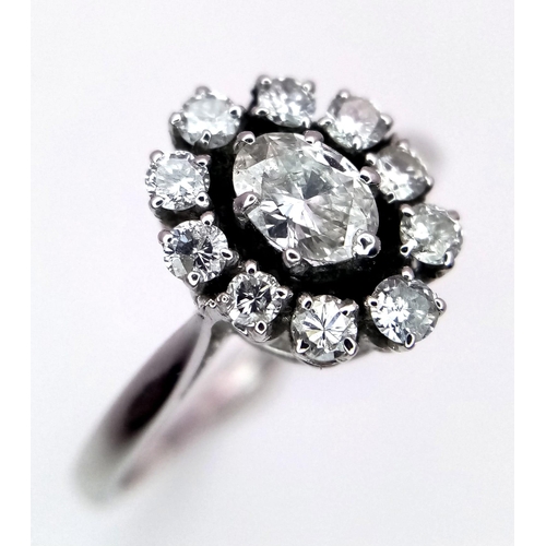 639 - A PLATINUM DIMAOND CLUSTER RING WITH A MARQUISE CENTRE STONE - 0.60CT. TOTAL 3.4G. SIZE O