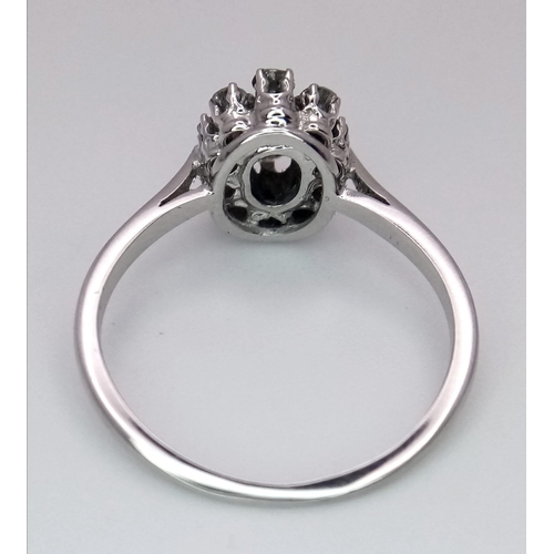 639 - A PLATINUM DIMAOND CLUSTER RING WITH A MARQUISE CENTRE STONE - 0.60CT. TOTAL 3.4G. SIZE O