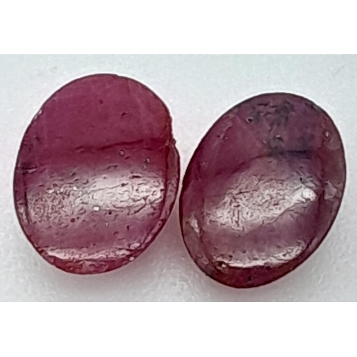 311 - A PAIR OF MATCHING OVAL CABOCHON RUBIES. 3CT ,  0.60g

A/S 2005